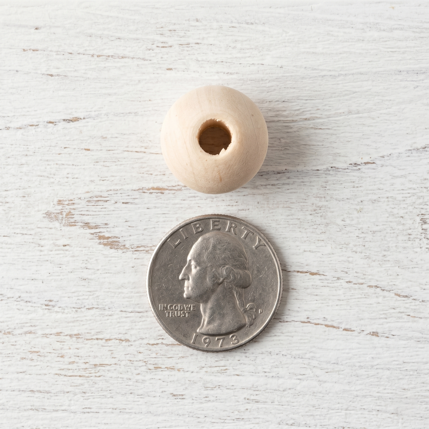 18mm high-quality wooden bead compared to the size of a quarter